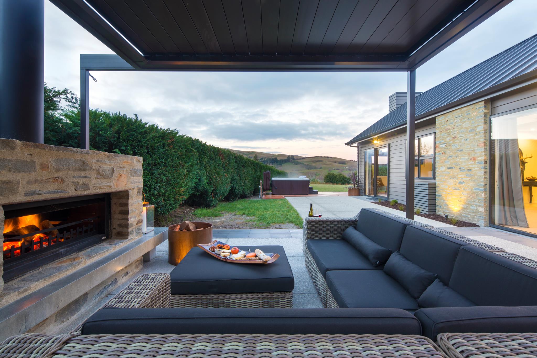 adding an outdoor fireplace to an outdoor entertaining area