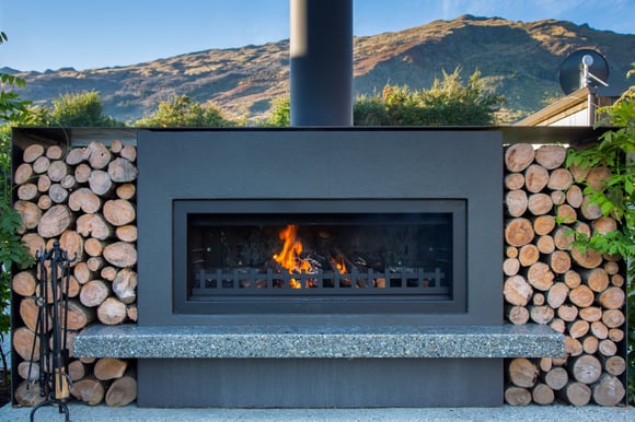outdoor entertaining area with an outdoor fireplace in Queenstown
