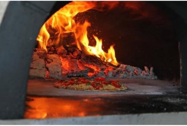 Cooking in a pizza oven