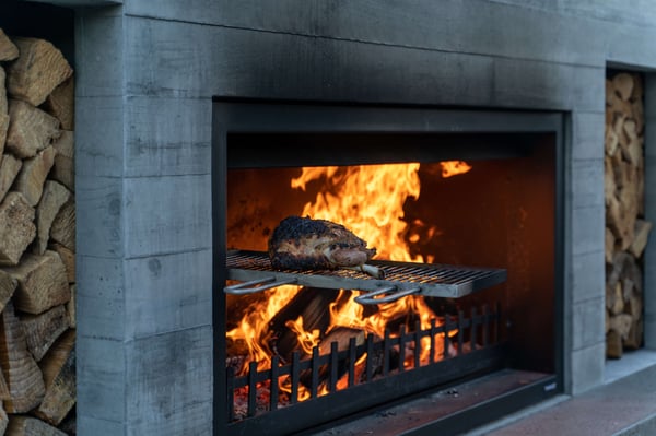 Outdoor fireplace with swinging cooking grill