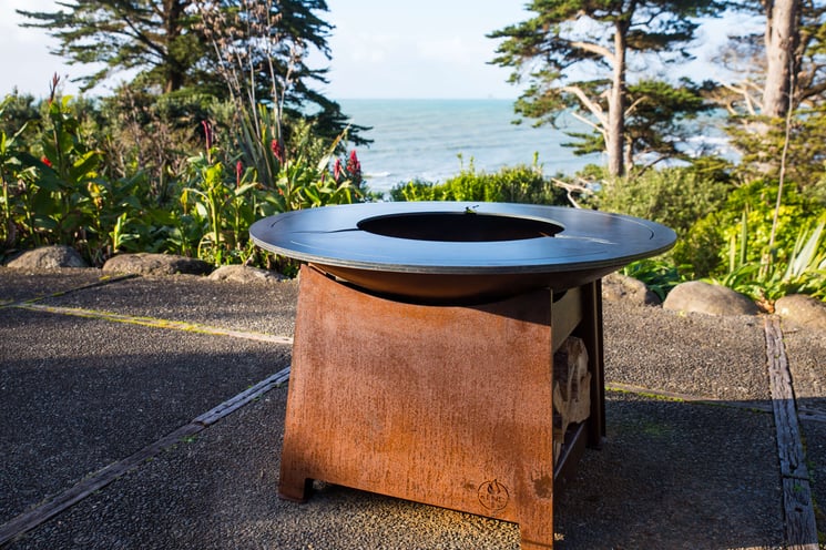 The design of a luxury fire pit includes an area for wood storage