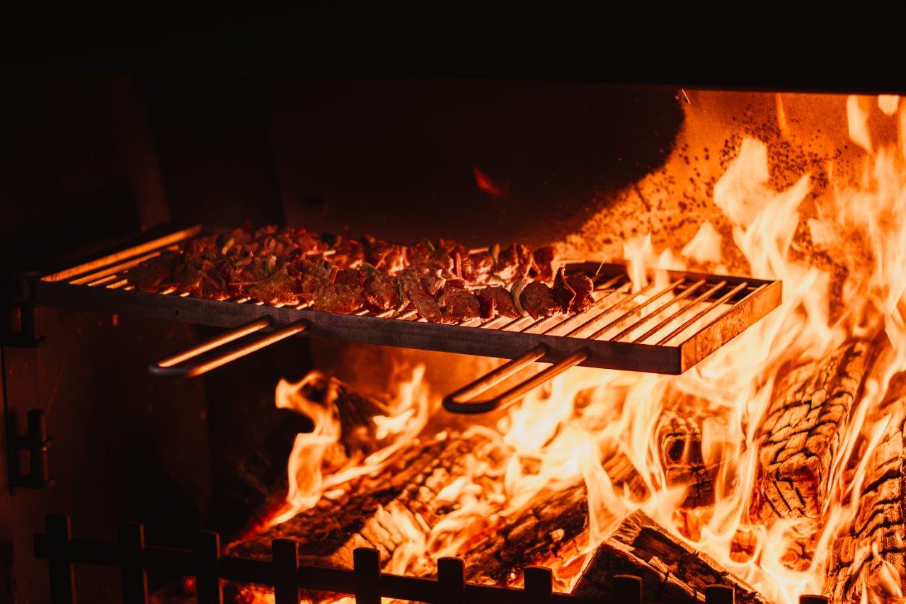 Outdoor fireplace with cooking grill 