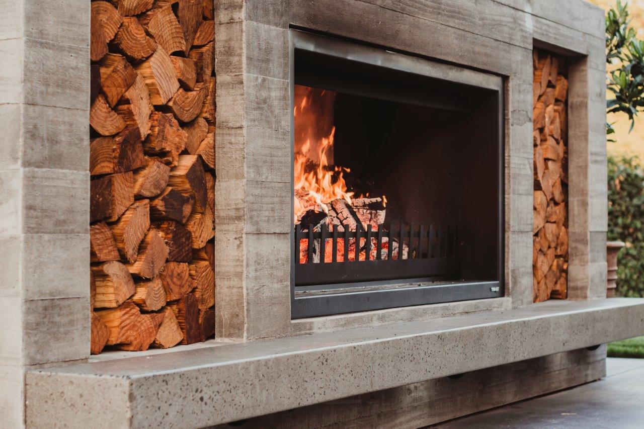 Wood-grain raw concrete finish on outdoor fireplace