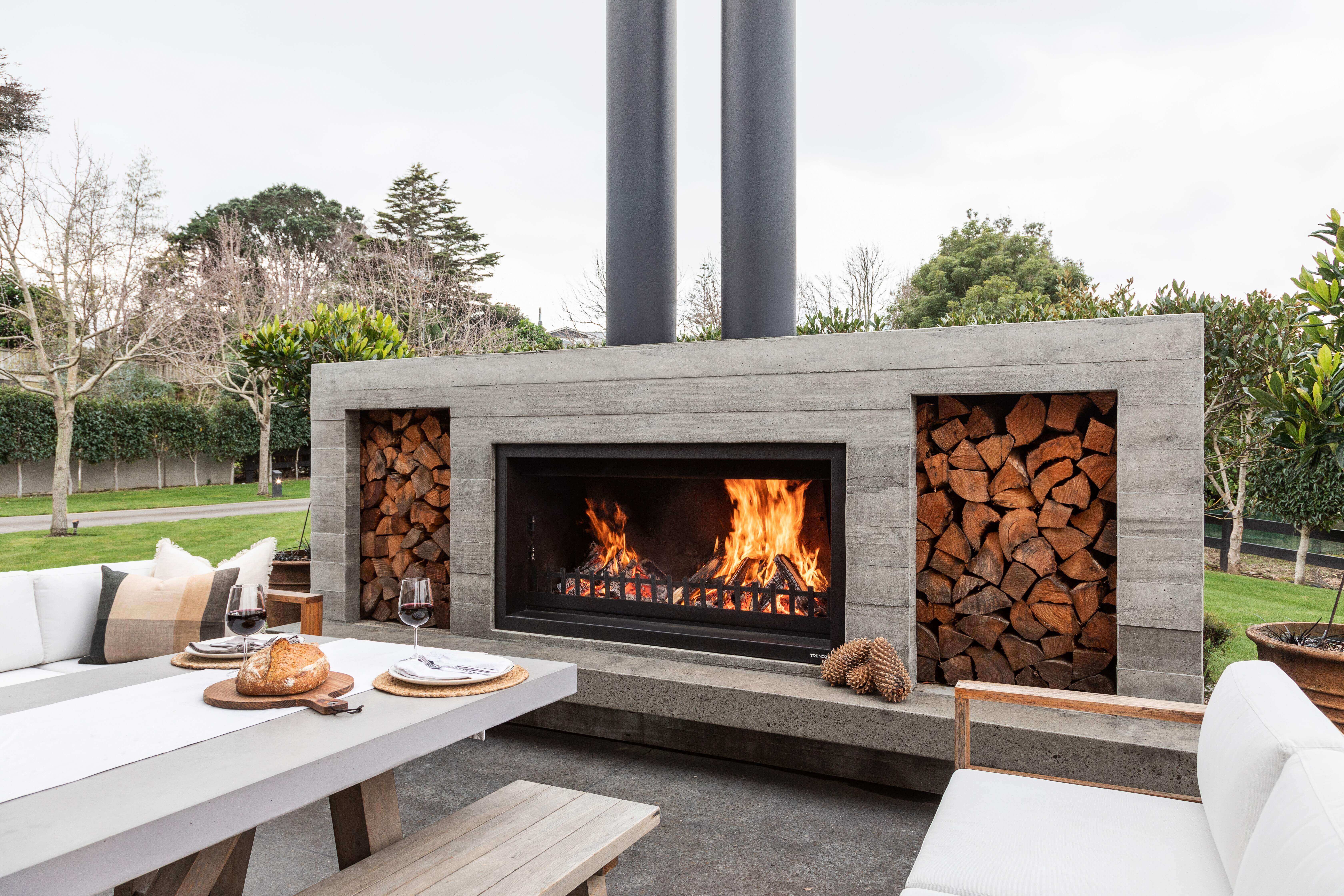 Twin peak Fireplace | Bare wood-grain concrete finish | Wood boxes | Hearth